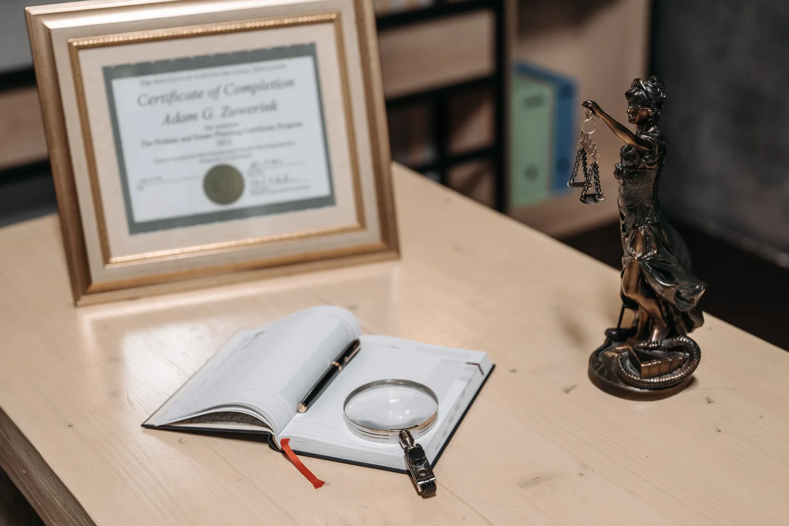 A framed certificate with Lady Justice statue on a wooden desk. How to judge an analytics certification before committing