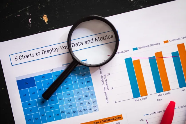 Close-up of business charts with magnifying glass highlighting data insights. Which data governance metrics are actually worth a target?