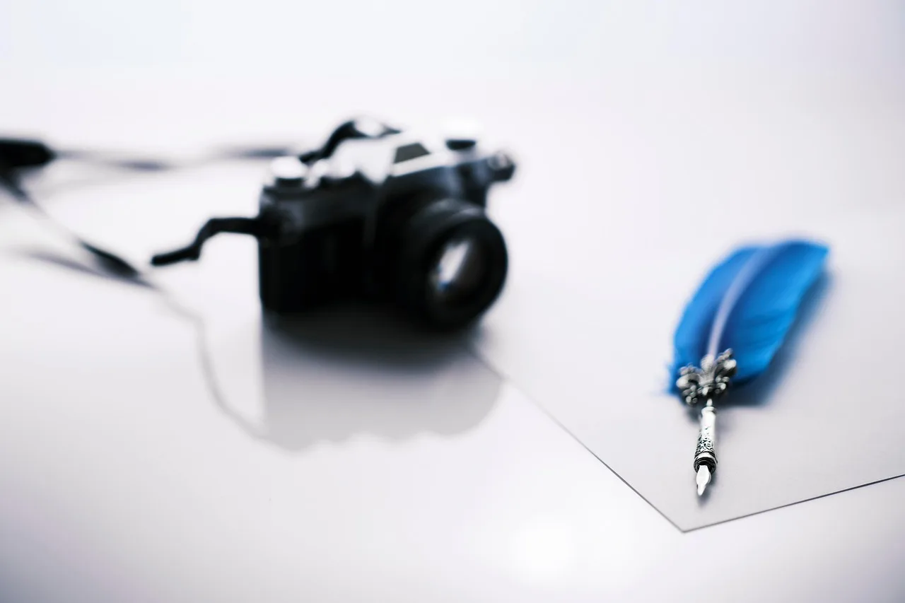 camera, quill, paper, feather, blue feather, silver quill, writing, news, journalism, pen, report, quill, quill, quill, quill, quill, blue feather. Grading a reporting explanation properly before it ships out the door